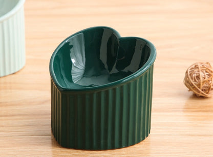 Green ceramic pet bowl inclined mouth designed for easy feeding of cats and small dogs