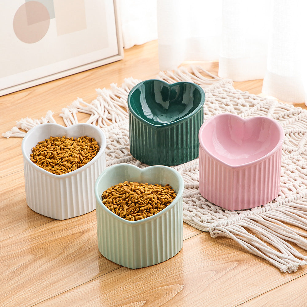 Ceramic pet bowl inclined mouth in heart shape, available in pink, green, white, and mint colors for cats and dogs